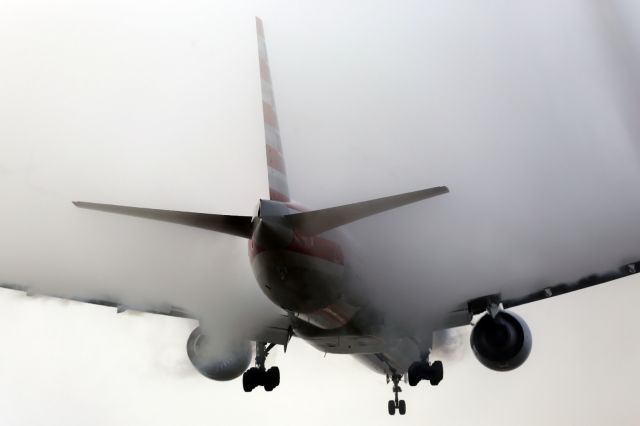 Boeing 777-200 — - AA B777-300ER, engulfed in condensation cloud, approaches runway 027L at LHR.