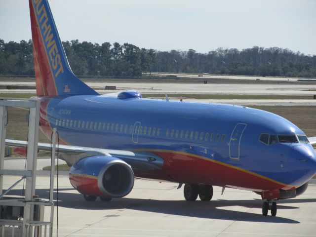 Boeing 737-700 (N240WN) - Inside terminal at Gate 128. (Plane arriving 129)