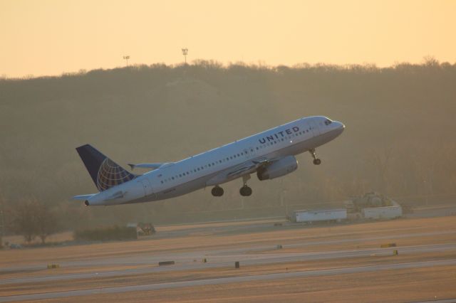 Airbus A320 (N404UA) - rotating from rwy 14R at sunrise