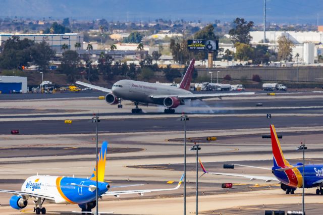Boeing 777-200 (N828AX) - An Omni Air 777-200 landing at PHX on 2/13/23, the busiest day in PHX history, during the Super Bowl rush. Taken with a Canon R7 and Canon EF 100-400 II L lens.