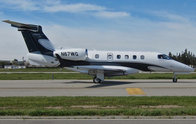 Embraer Phenom 300 (N67WG) - PHENOM 300 taxiing prior to take off at the Van Nuys Airport.