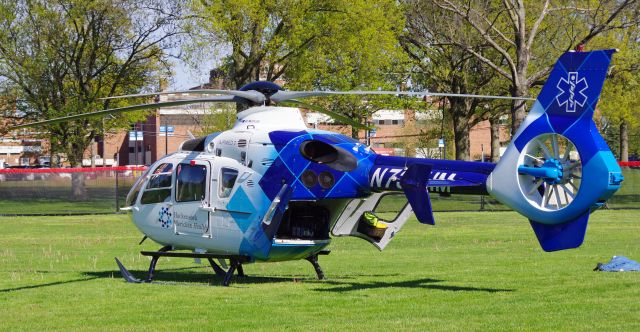 Eurocopter EC-635 (N732HM) - RAHWAY, NEW JERSEY, USA-MAY 09, 2022: A medical transportation helicopter is seen on the ground in front of the Rahway Middle School preparing for a flight from Robert Wood Johnson Hospital-Rahway, N.J. to Robert Wood Johnson Hospital-New Brunswick, N.J. When transporting to or from RWJ-Rahway, the helicopter will use the school's ball field as a landing zone because the hospital lacks a permanent fixed heli-pad. As such, it uses the nearest fixed heli-pad as its landing code, Merck & Company's 7NJ8, located about a mile away.