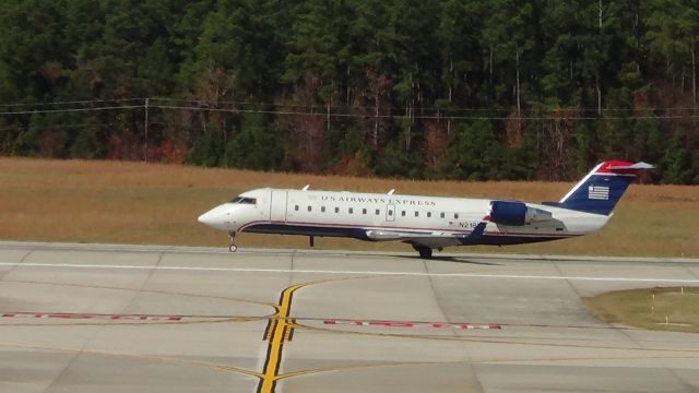 Canadair Regional Jet CRJ-200 (N218PS) - N218PS landing roll out on 23R