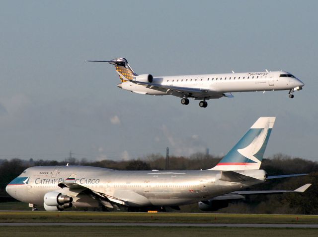 Canadair Regional Jet CRJ-900 (D-ACNG) - Eurowings new CRJ9NG lands as a Cathay Cargo B74.4BCF  approaches the runway threshold.