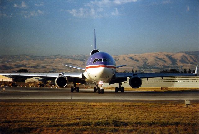 Boeing MD-11 (N611FE) - KSJC - Late summer Freighter run in full progress at KSJC - This old colors Federal Express MD-11 48604/553 - positions to 30 L for a departure to Memphis. This jet written off at Newark, New Jersey on 31/July/1997.