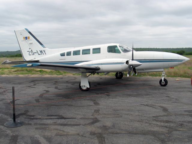 Cessna 402 (ZS-LMY) - At South Africa. Note the electric fence around the aircraft to prevent animal chewing on tires and brake lines.