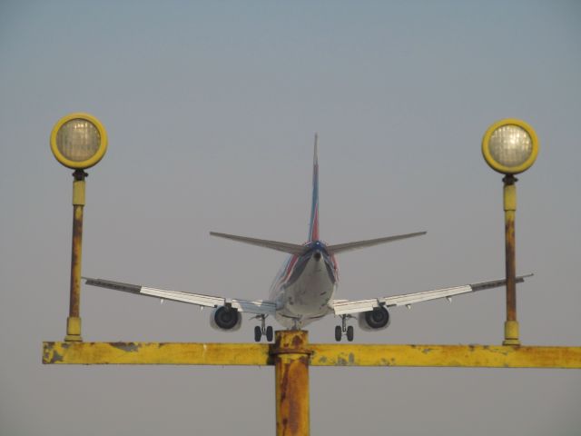 BOEING 737-400 — - Pilot hit the ground, bounced, and then smashed down with one wheel barely on the runway