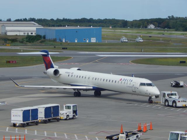 Canadair Regional Jet CRJ-900 (N136EV) - A Delta CRJ900 pushes back from gate at KALB.