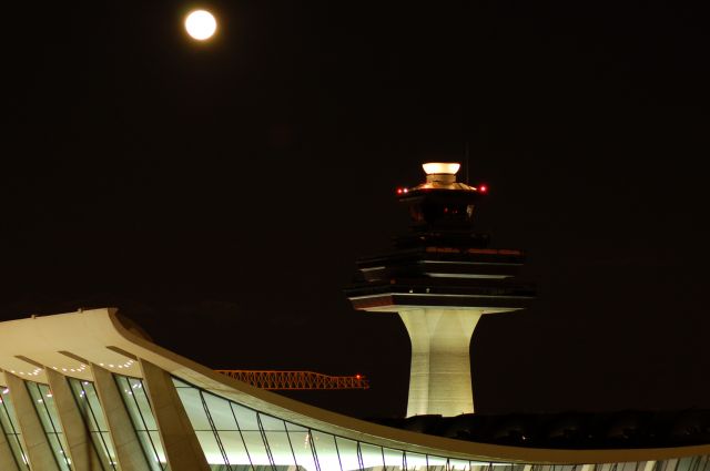 — — - The moon shines over what is, in my opinion, the most beautiful airport terminal in the world.