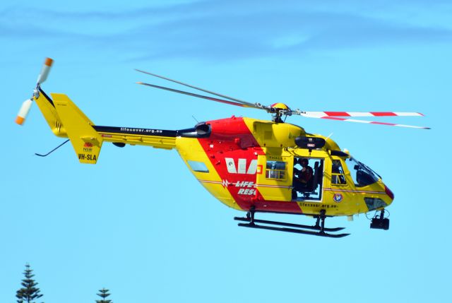 NUSANTARA NBK-117 (VH-SLA) - Lifesaver helo departing Merry Beach, NSW, following a medivac operation 4 Feb 2018.br /br /Main rotor cap is styled &amp; coloured like a real life saver cap - cute.