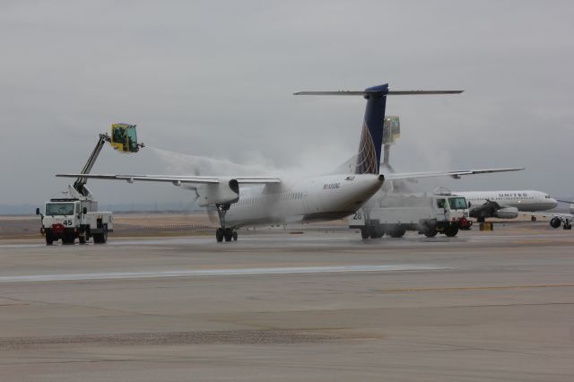 de Havilland Dash 8-400 (N345NG) - Deice operations at DIA on a cold and grey day.