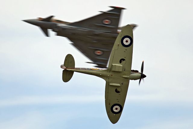 SUPERMARINE Spitfire — - History and the Present.  RAF Typhoon and Spitfire cross each other at RIAT 2015, Fairford, UK.