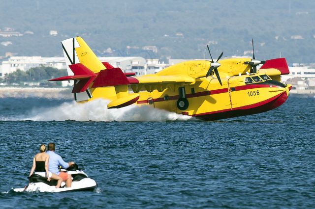 — — - Taken today 28 July 2013 in Palma Bay, Mallorca. Big land fire near Andratx lots of water bombers picking up water. Canon 5D Mk2 300/2.8, couple in foreground out of depth of field (focus) but adds atmosphere