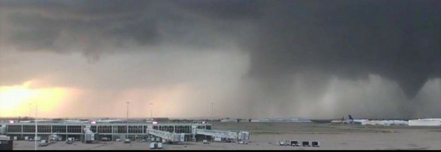 — — - A tornado passing just north of the Tulsa International Airport.