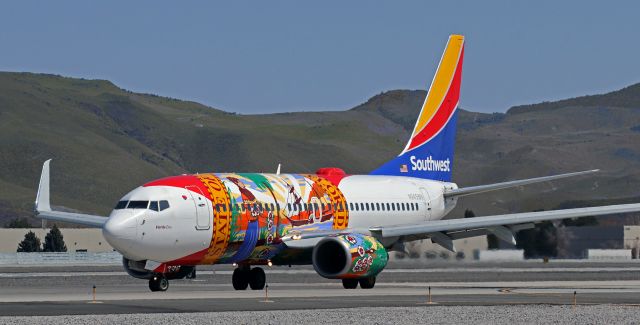 Boeing 737-700 (N945WN) - N945WN, Southwest's "Florida One," makes the turn from Taxiway November to head to the terminal after landing on Runway 16R.br /(And yes, for those of you who have eagle-sharp eyes, you are indeed seeing correctly. Although you can only see one of them in this photo, that is definitely what you think it is -- Florida One now has split scimitars. They were installed less than four weeks ago. I have another pic that shows the one on the port side wing very clearly and if I get a free moment or two I'll post it.)