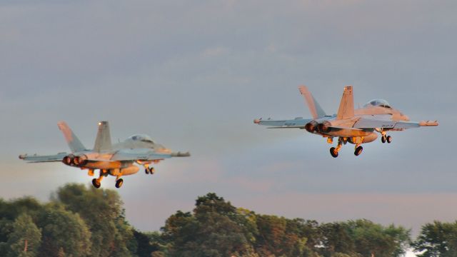 McDonnell Douglas FA-18 Hornet (16-9132) - 523 (169132) & 506 (168773) of the U.S. Navy E/A-18G Growler Demo Team, VAQ-129, blasting off of runway 18 to open up the Wednesday evening Air/Firework-Show at EAA AirVenture 2023. br /br /7/26/23