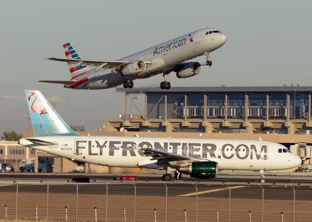 Airbus A320 (N223FR) - N536UW is taking off from 7L while N223FR is waiting to cross at F10. 