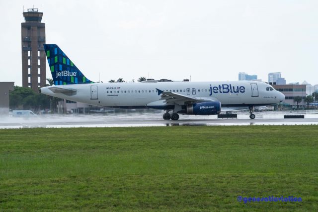 Airbus A321 (N599JB) - Grey overcast rainy day departure from FLL airport.  Viewed from aircraft observation park located-1800 SW 39th St, Fort Lauderdale, FL 33315