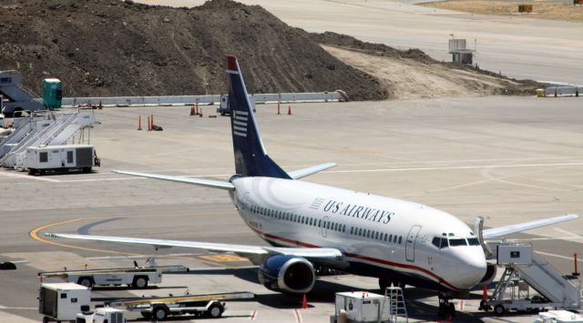 Boeing 737-700 (N154AW) - Lack of Jetway extending to aircraft, says "Terminal C". US Airways jet (Former America West) sits where Terminal B, is now located. At the time this image was shot, the jet was located South of the current Gate 28 area.