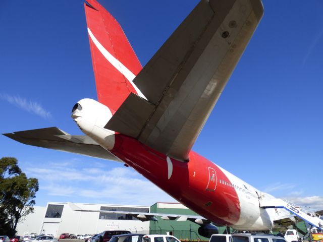 Boeing 747-400 (VH-OJA) - Standing under the tail section of VH-OJA now in retirement at Wollongong Regional Airport.