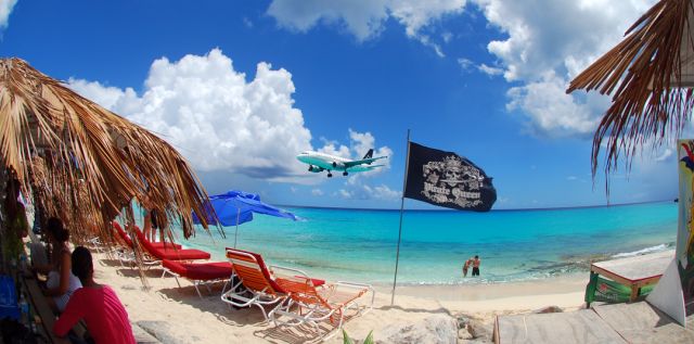 Airbus A319 (N701UW) - Driftwood Boat Bar has replaced Sunset Beach Bar as the place to be on Maho, St. Maarten.