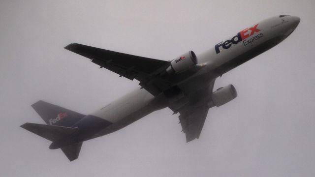 BOEING 767-300 (N133FE) - "Boden" departing 36L on a foggy afternoon.