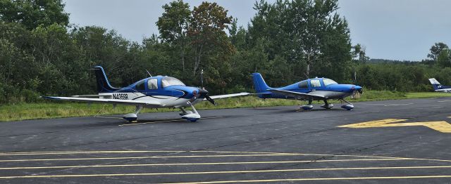 Cirrus SR-22 (N435SR) - Twinsies on the transient aircraft tie down pads! The Cirrus in the foreground is owned by Presidential Advisor and well respected author, James Fallon. Mr. Fallon and his wife had flown up to Eastport to spend a few days enjoying the city between a series of scheduled book readings he provided for the dozens of eager fans who flocked to Eastport from across the region.