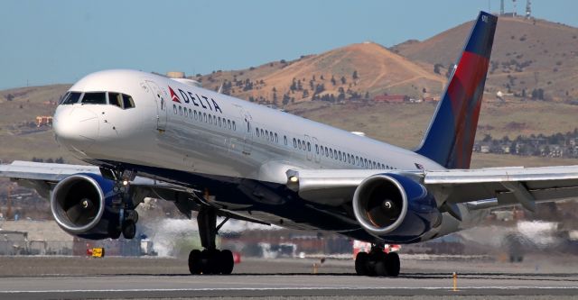 Boeing 757-200 (N6703D) - Delta's N6703D has the mains on the 16L concrete and is going dirty as the nose gear is about to touch down in this pic taken shortly before high noon (at 11:40 AM) as the DAL Seven Five completes a morning trip from Atlanta.