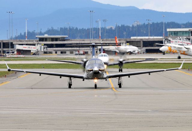 Pilatus PC-12 (C-GCRN) - Followed by a Pacific Coastal B1900 at Exit Alpha