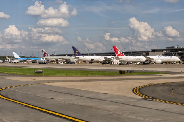 Boeing 787-9 Dreamliner (TC-LLN) - 13th July, 2022: Line-up of heavies from Asia and Europe at golden hour at Washington Dulles International Airport. Seen from right to left are Turkish Airlines Dreamliner (TC-LLN, B789); Saudia B773 (HZ-AK43); Qatar Airways B773 (A7-BEE); KLM A333 (PH-AKA).  Also seen are Etihad Dreamliner and United puddle-hoppers.