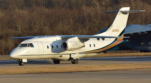 Fairchild Dornier 328JET (N411JF) - One of Deltas (technically Atlantic Coast Jet) old J328s pulling in during golden hour. That beautiful C17 in the background came in to pick up Trumps motorcade after he and Melania gave speeches here in Ohio. I was originally at Lunken for the C32, and about an hour after they left the C17 came in. 