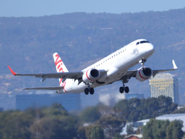 Embraer ERJ-190 (VH-ZPT) - Getting airborne off runway 23 on a beautiful Adelaide autumn day. Thursday 12th April 2012.