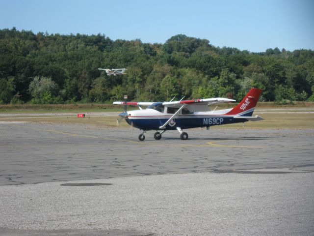 Cessna Skylane (N169CP) - Turning around after a runup with N80638 taking off on runway 14 in the backround