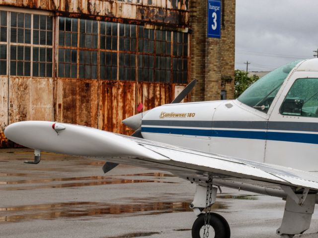 Beechcraft Sundowner (N18889) - A Beechcraft Sundowner sits in the rain at Lunken.