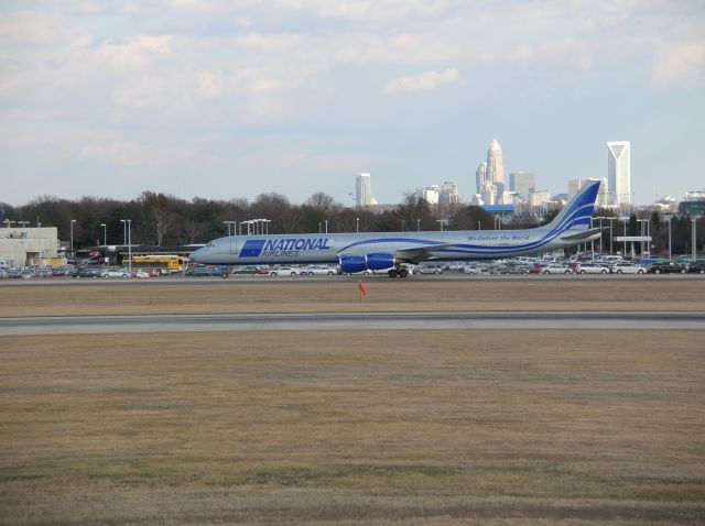 McDonnell Douglas DC-8-70 (N155CA) - N155CA taxiing to 18C for a trip back home to Michigan. With the lovely Charlotte skyline in the background.