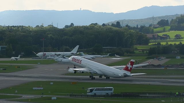 Airbus A340-300 (HB-JMA) - takeoff to Shanghai, in the backgroud Boeing Rolling Stones