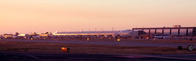 KSJC — - Sunset hitting the west side of the Terminals and Garage, Looking from near the South end of 30L