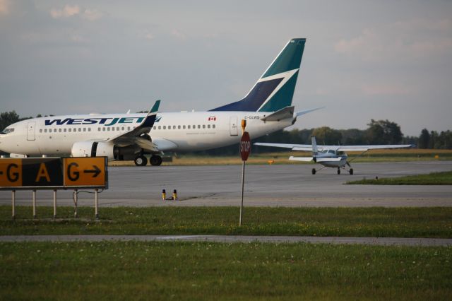 Boeing 737-700 (C-GLWS) - Westjet arriving from out west,Landing At London International Airport,CYXU