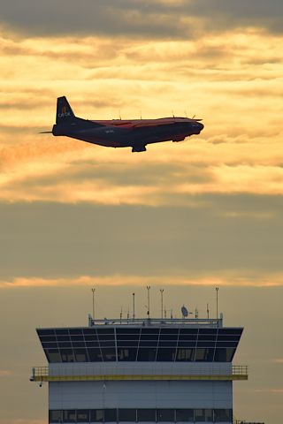 Antonov An-12 (UR-CKL) - 04-28-25 departure silhouetted over FedEx Ramp Tower.