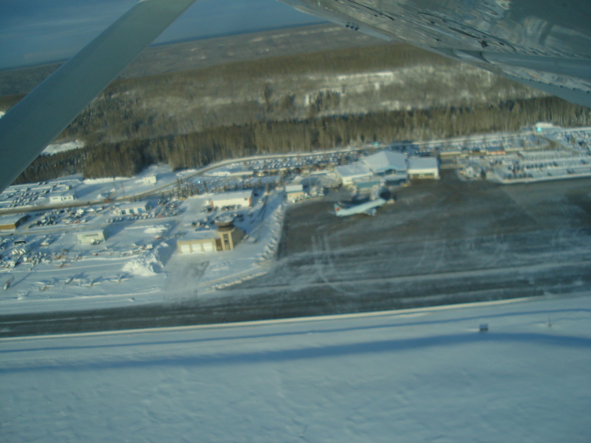 Embraer ERJ-190 — - View of main terminal at Fort McMurray Airport, Alberta, Canada on a cold winter day. Air Canada Embraer 190 is parked at the passenger bridge.