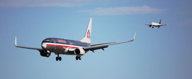 Boeing 737-800 (N946AN) - Landing on 16L. Delta Airbus behind it is actually landing on 16R.