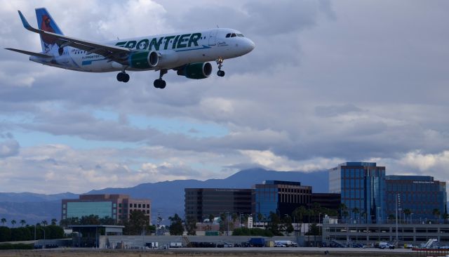 Airbus A320 (N228FR) - Frontiers "Orville" just seconds from touchdown on runway 20R in Santa Ana, CA. The rain had stopped not too long before this one arrived and made for a neat cloud formation in the background of the shot.