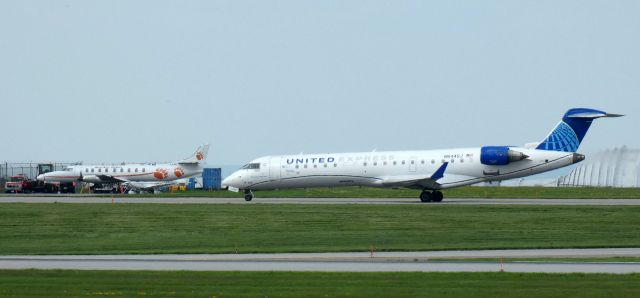 Canadair Regional Jet CRJ-700 (N544GJ) - Taxiing to parking is this 2006 United Express Mitsubishi Canadair Regional Jet 550 in the Spring of 2024. The other aircraft with the bear prints is a SW4 Metroliner.