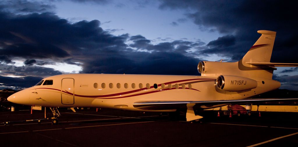 Dassault Falcon 7X (N715FJ) - The ramp lighting at KRTS casts a colorful glow over N715FJ, a Dassault Falcon 7X, as the final few minutes of dusk illuminate the sky in the background.  The Falcon was flown in demonstration performance flights during the National Championship Air Race events that concluded yesterday at Reno Stead Airport.