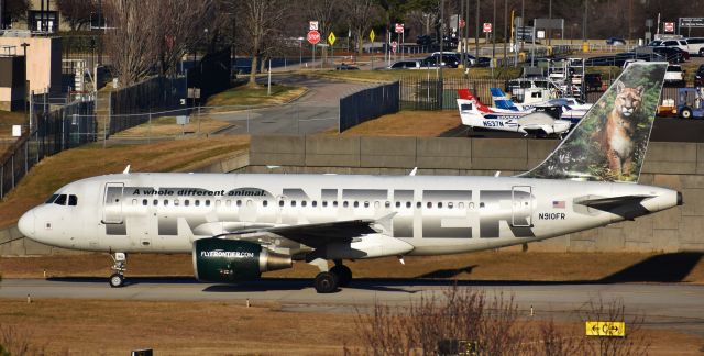 Airbus A319 (N910FR) - This one lit up my day, being a crazy cat lady! Sal the Cougar crossing over C to curl up next to T2.  From the RDU parking deck, 12/28/17.