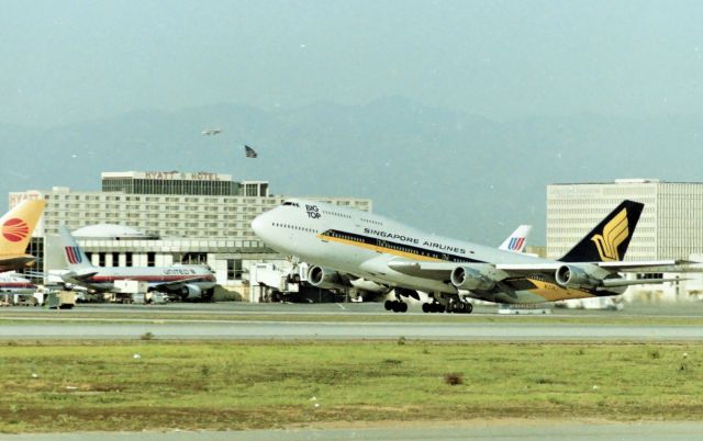 BOEING 747-300 (N123KJ) - KLAX - March 1989_? Singapore Girl -300 departing 25R for___? I was able to get video of the same jet powering up on 25L for departure from the FedEx lot a few years later- sounded so sweet,,,,