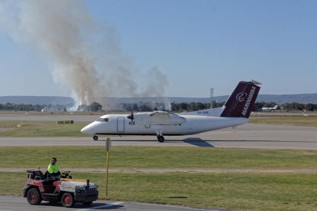 de Havilland Dash 8-100 (VH-QQK) - 29 May 2015 - Fire in the background