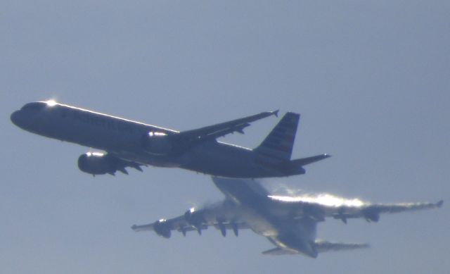 Boeing 747-400 (G-CIVZ) - Attempting to take a photo of the Jumbo Jet when this AA N192UW flys right through the scene both heading for a landing at the Airport in the Winter of 2018.  