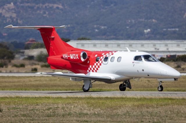 VH-MQX — - A brand new Embraer Phenom taxis by for a runway 05 departure. 