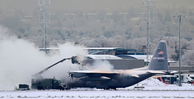 Lockheed C-130 Hercules (92-0549) - A NevANG C-130H (920549) is being deiced in preparation for a flight. The trees in the background, somewhat difficult to see due to a blanket of fog that is slowly being dissipated as the sun gets higher in the sky, are encased in the same snow and ice as Roller Four Nine and illustrate why it took a few minutes for the ground crew to completely deice the Hercules.